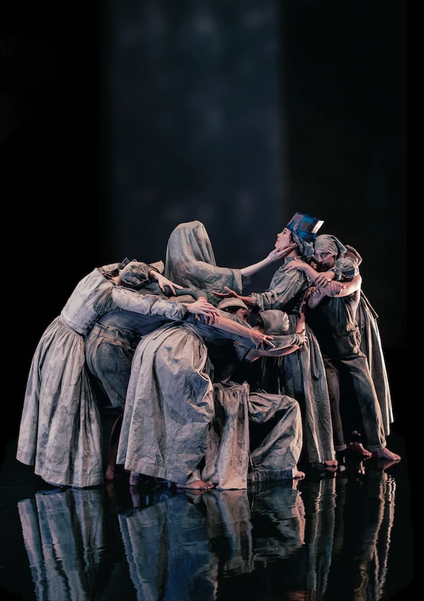 The Thrice ensemble gathered together on a dark, reflective stage.